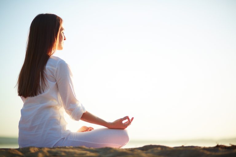 Hands resting on knees in a calm pose - peaceful moment during meditation near Reading