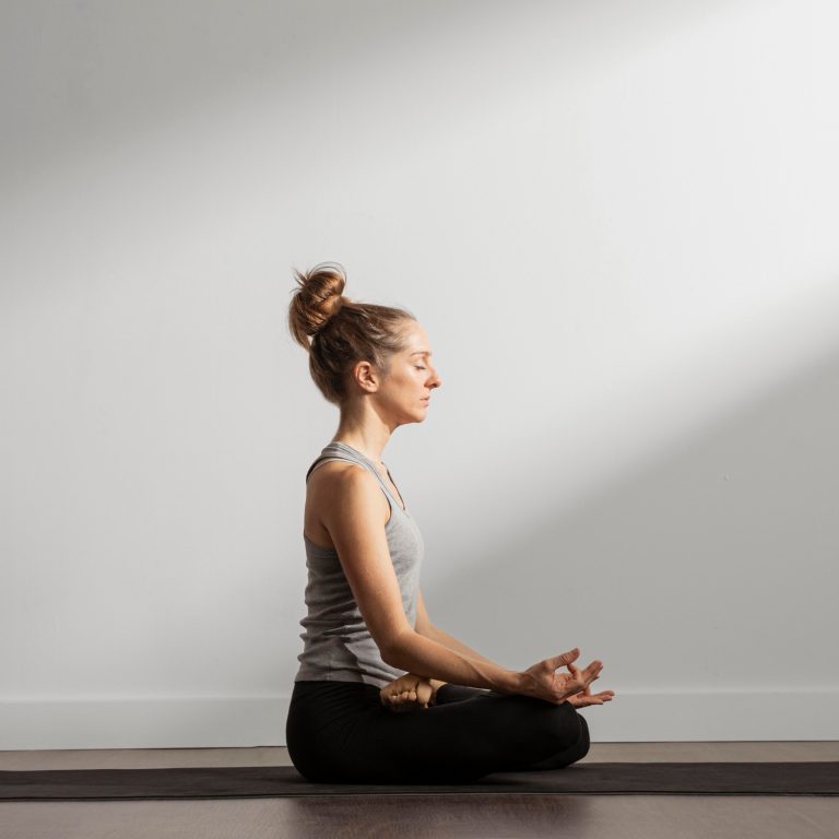 Person seated cross-legged in calm room - meditation near Newbury moment