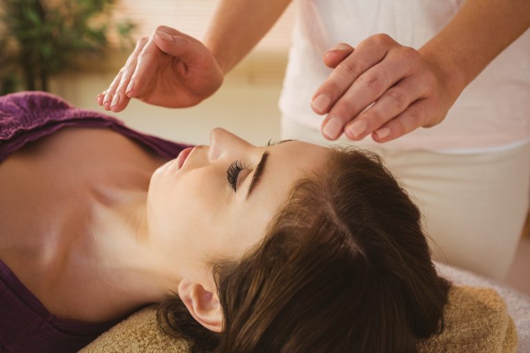 Hands placed gently above the body - energy reiki session near Newbury