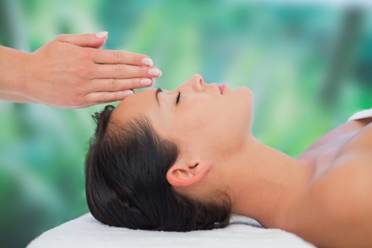 Person resting on treatment table - relaxing reiki Windsor session